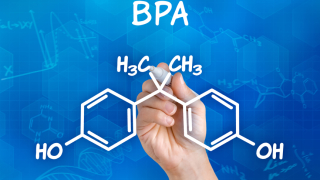 Hand with pen drawing the chemical formula of BPA